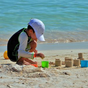 Boy Playing in Sand in Akumal, Mexico - Encircle Photos