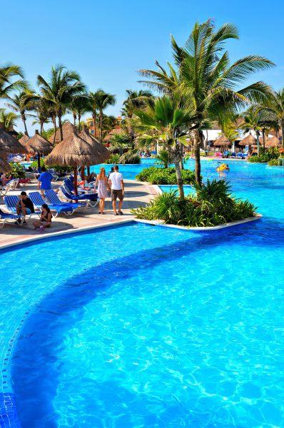 Couple Holding Hands at Pool at Riviera Maya, Mexico - Encircle Photos