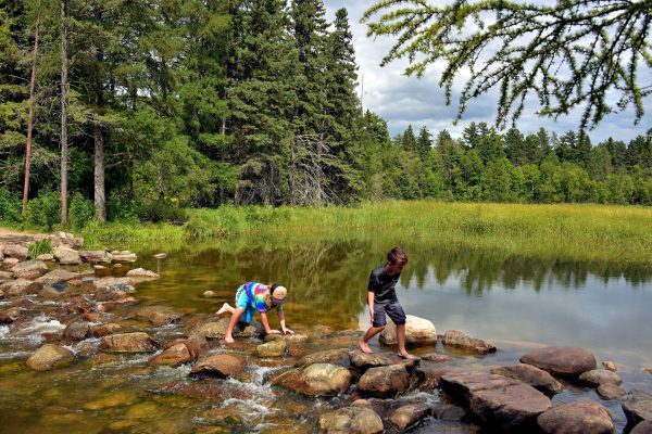 Boys Crossing Mississippi River Headwaters in Park Rapids, Minnesota - Encircle Photos