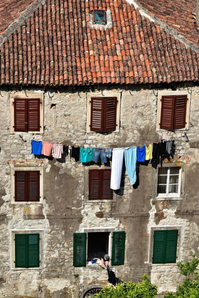 Woman Hanging Laundry in Kotor, Montenegro - Encircle Photos