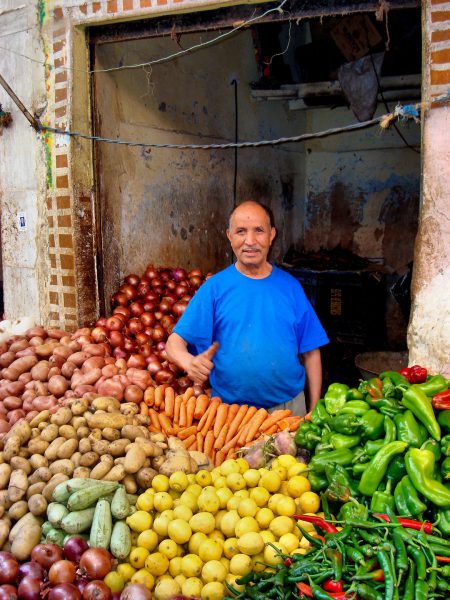 Merchant in Vegetable Stand at Old Medina in Casablanca, Morocco - Encircle Photos