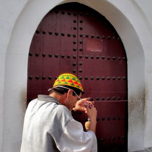 Moroccan Man Spinning Thread on Forehead in Marrakech, Morocco - Encircle Photos