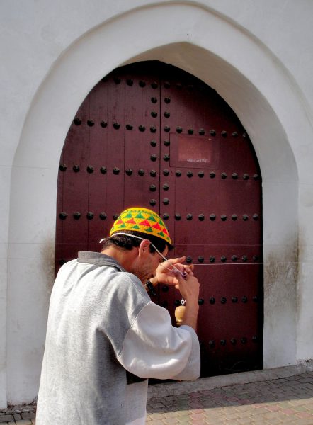 Moroccan Man Spinning Thread on Forehead in Marrakech, Morocco - Encircle Photos