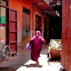 Woman in Djellaba Hurries from Market in Marrakech, Morocco - Encircle Photos
