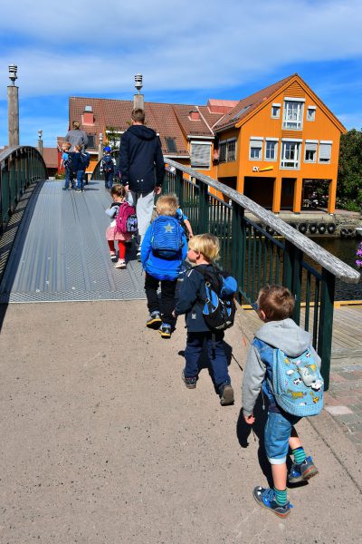 Row of Children Walking over Footbridge in Kristiansand, Norway - Encircle Photos