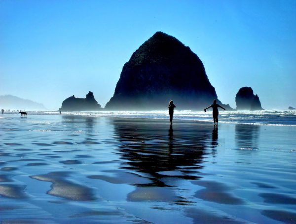 Barefoot in Pacific Ocean next to Haystack Rock at Cannon Beach, Oregon - Encircle Photos
