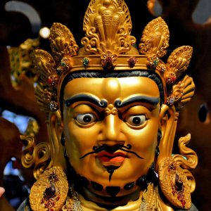 Yellow Dzambhala Statue in Buddha Tooth Relic Temple in Chinatown, Singapore - Encircle Photos