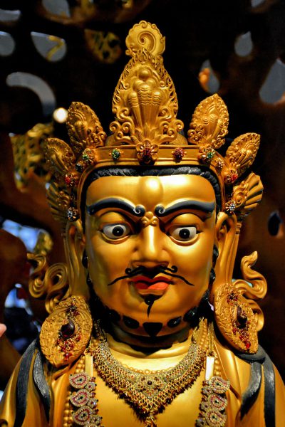 Yellow Dzambhala Statue in Buddha Tooth Relic Temple in Chinatown, Singapore - Encircle Photos