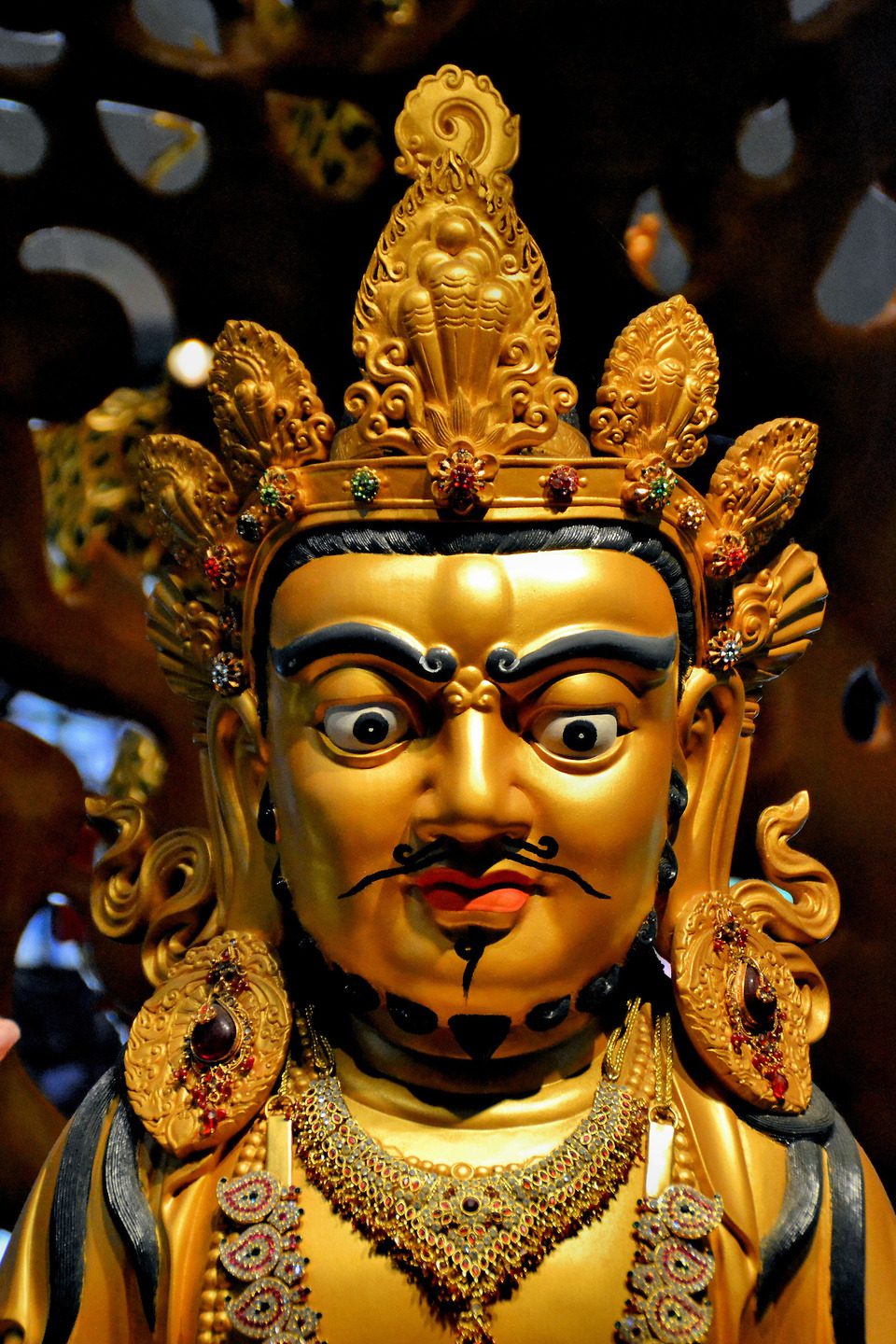 Yellow Dzambhala Statue in Buddha Tooth Relic Temple in Chinatown, Singapore - Encircle Photos