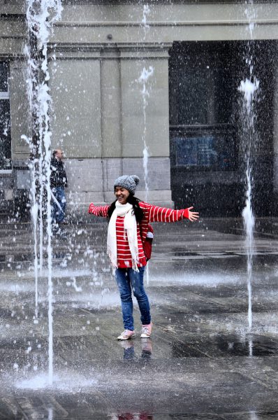 Young Woman Dancing in Federal Square Fountain in Bern, Switzerland - Encircle Photos
