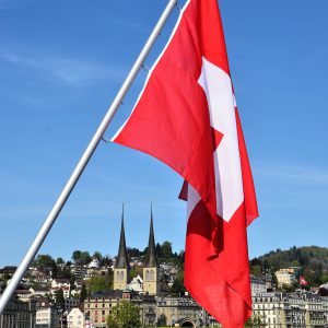 Rectangular Swiss Flag Flying over Lake Lucerne in Lucerne, Switzerland - Encircle Photos