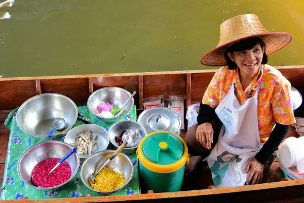 Merchant in Boat at Taling Chan Floating Market near Bangkok, Thailand - Encircle Photos