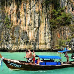 Tourists Riding Longtail in Pileh Cove on Phi Phi Ley, Thailand - Encircle Photos