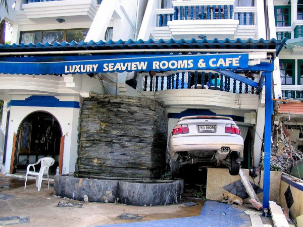 Dog Below Car Wedged in Hotel After Tsunami on Patong Beach in Phuket, Thailand - Encircle Photos