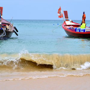 Two Longtail Boats Near Shore of Patong Beach in Phuket, Thailand - Encircle Photos