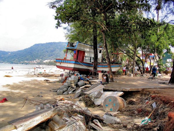 Teens Stare at Water Among Wreckage After Tsunami on Patong Beach in Phuket, Thailand - Encircle Photos