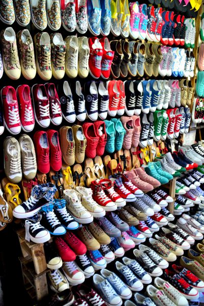 Colorful Tennis Shoes and Sandals Displayed on Hang Dau Street in Hanoi, Vietnam - Encircle Photos